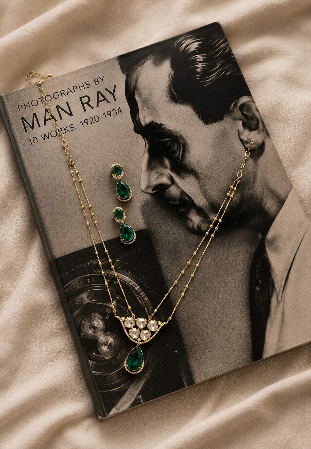 Emerald green kundan pendant necklace set with matching teardrop earrings in a gold finish