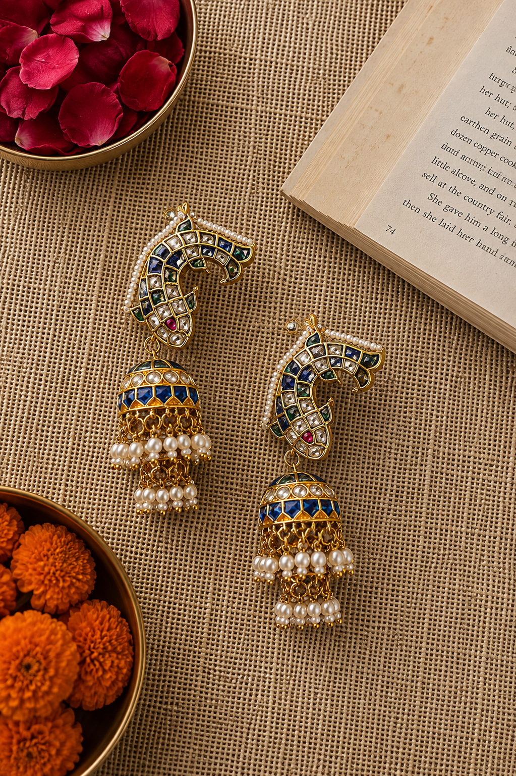 Royal meenakari kundan jhumka earrings with blue enamel detailing and pearl tassels.