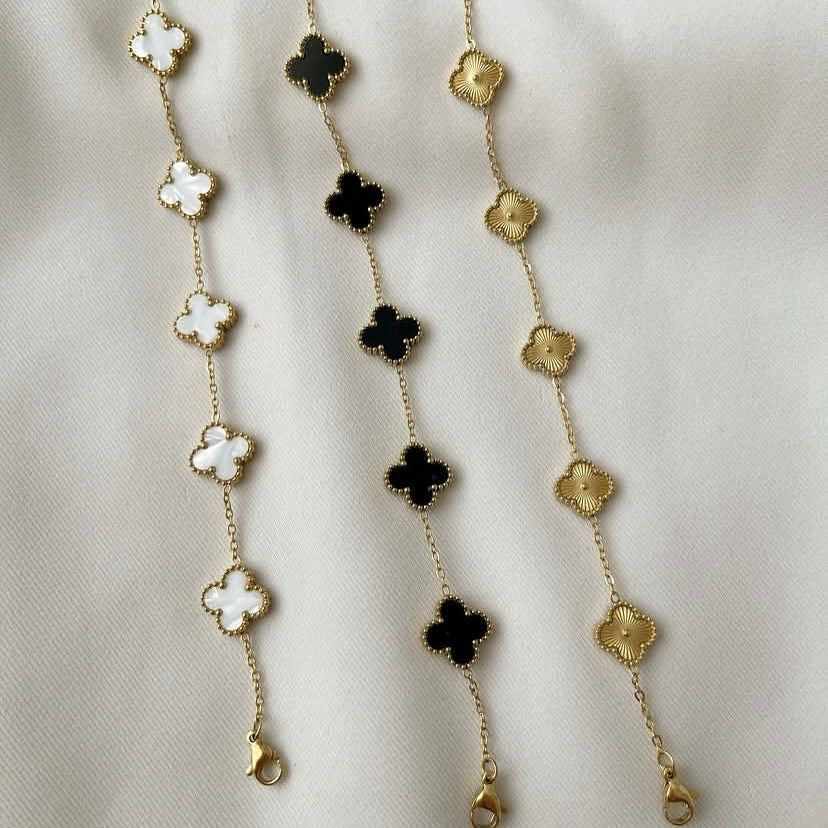 Necklace with floral pendants on a beige fabric background