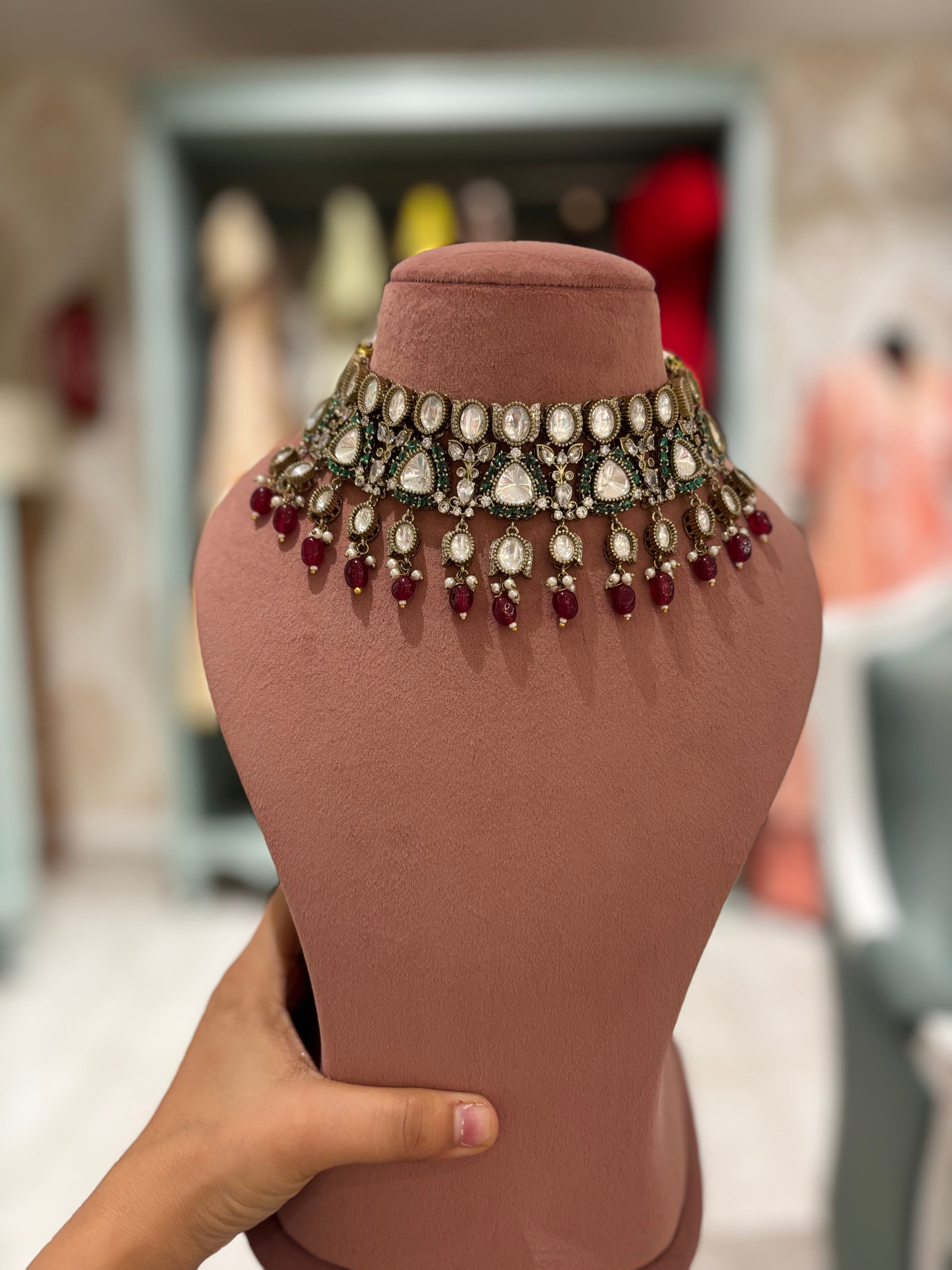 Victorian polki choker featuring emerald detailing and ruby bead drops in an antique finish.
